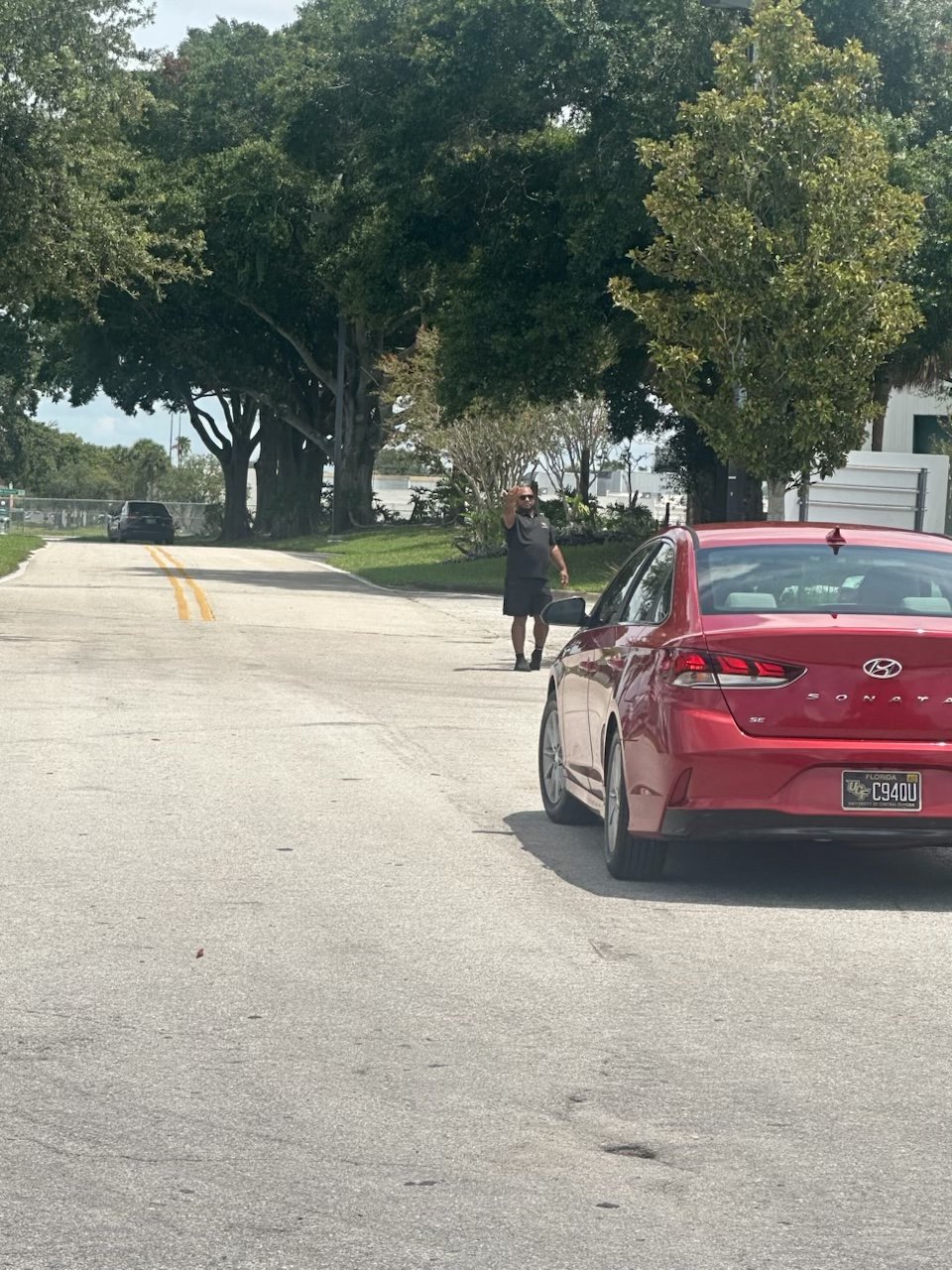 WC Parking attendant directing vehicle traffic on-site